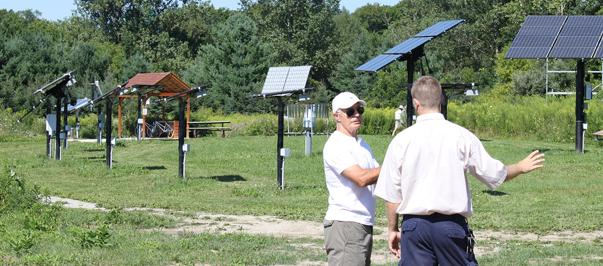 tour guide and visitor explore solar field at Kortright Centre