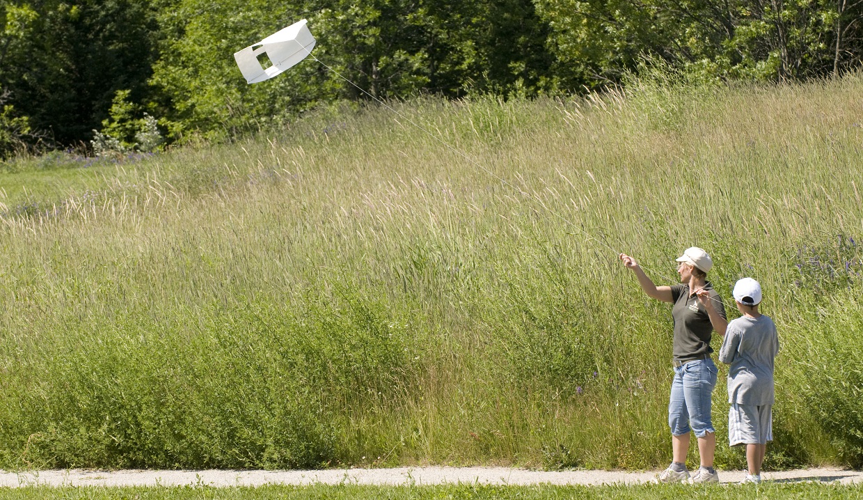 student and teacher fly kite at Kortright Centre