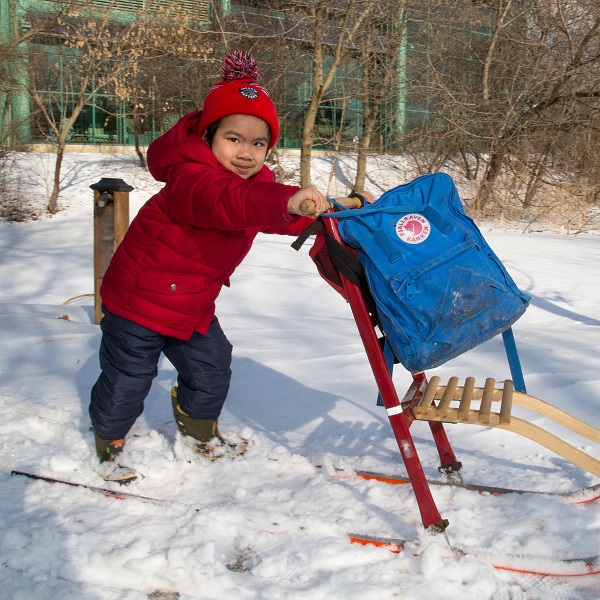 child plays with sled at Kortright Centre Family Day open house