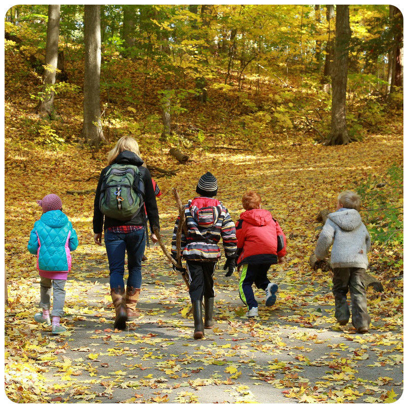 mother and children enjoy family adventure walk in the forest at Kortright Centre