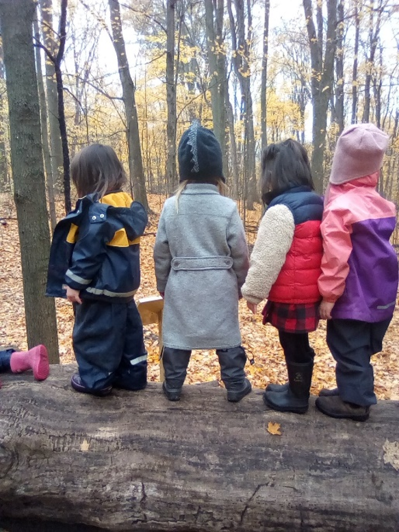 children balance on log at Kortright Centre Nature School