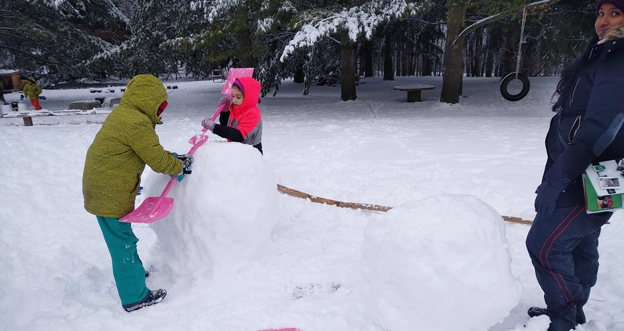 Nature School students build snowperson