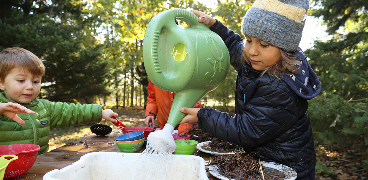 children play in mud kitchen at Kortright Centre Nature School