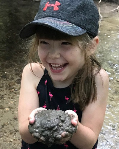 summer camper enjoys mud madness experience at Kortright Centre