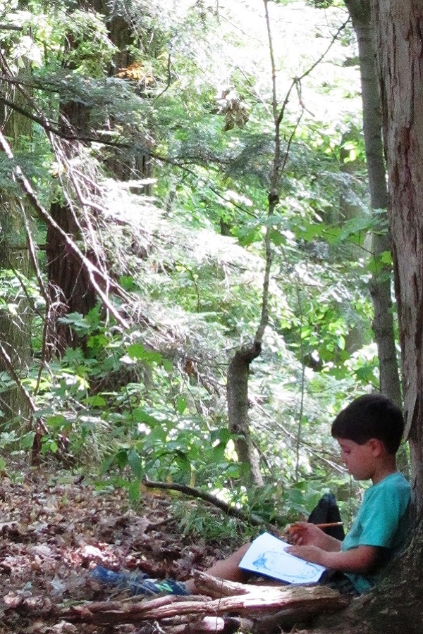 summer camper discovers the magic of the forest at Kortright Centre