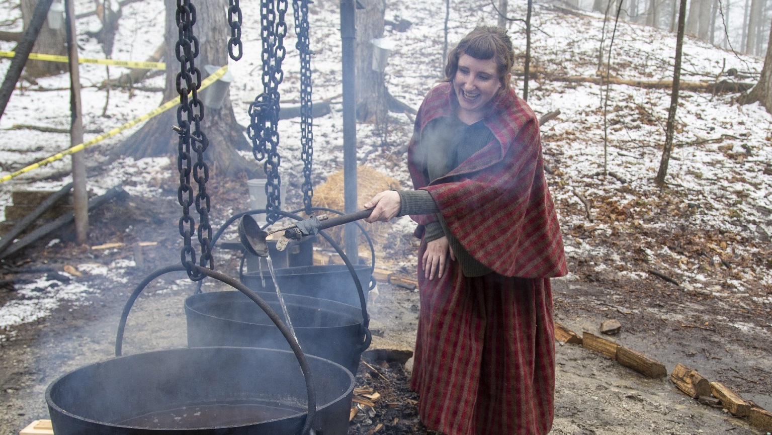 educator at Kortright Centre for Conservation demonstrates traditional method of making maple syrup