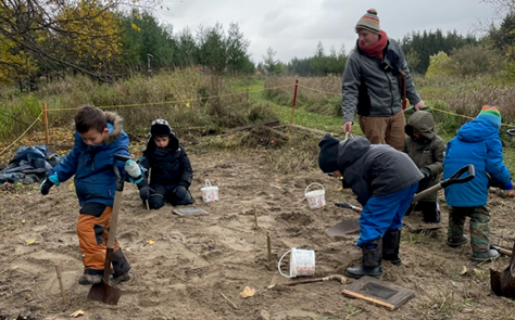The Nature School students enjoy an activity in their new sandbox