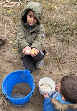 The Nature School students enjoy an activity in their new sandbox