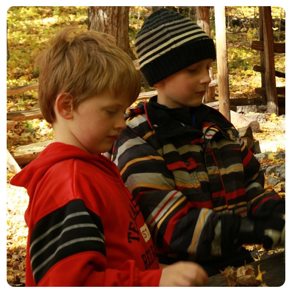 Nature School students make forest crafts with instructor