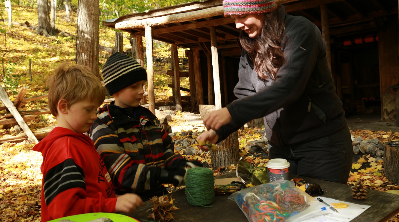 Nature School students make forest crafts with instructor