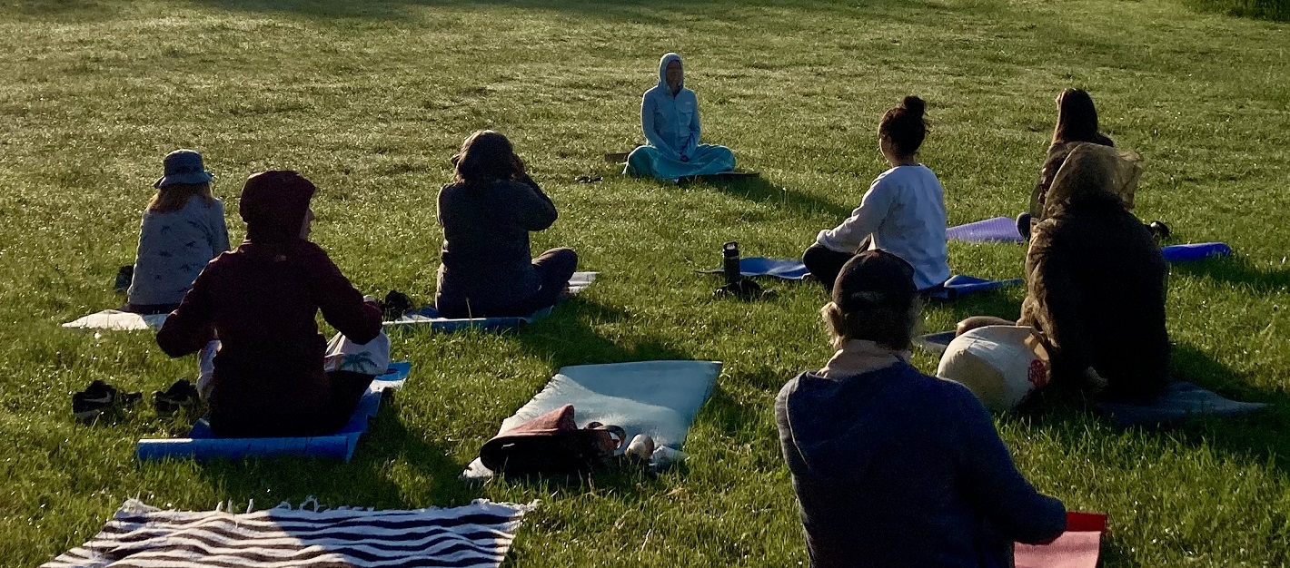 an instructor leads a yoga session during a mindfulness retreat at Kortright Centre for Conservation